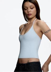 Detail shot of light blue halter neck crop top with open back and elastic matte fabric