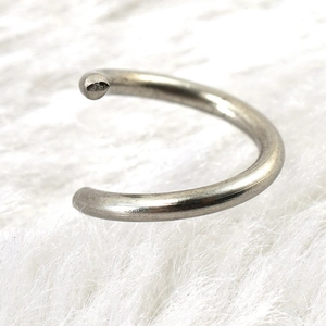 Polished silver stainless steel open jump ring on white fur background for DIY jewelry