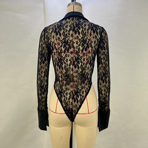 Detail of the sheer floral lace back and buttoned cuffs on a black long sleeve bodysuit