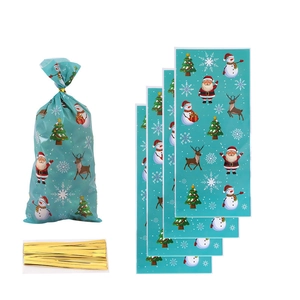 Detail of Christmas OPP treat bags with Santa Claus prints and gold twist ties