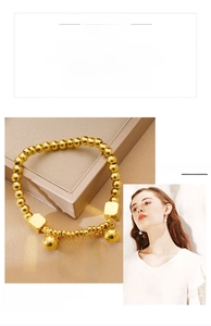 Detailed view of a gold beaded necklace featuring an engraved Eternal Love round pendant