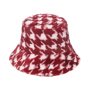 Detailed view of the soft red and white houndstooth plush fabric on a warm winter bucket hat