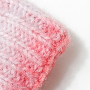 Detailed macro shot of the soft pink and white gradient plush knit fabric texture