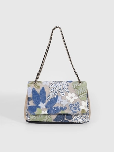 Detail of floral sequin embroidery and gold-tone chain on a beige woven shoulder bag