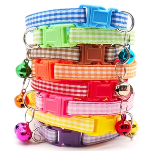 Close-up of stacked Christmas pet collars with festive snowflake prints and metal bells