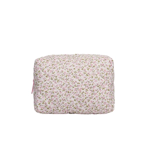 Quilted floral cotton cosmetic bag with pink flower pattern and zipper closure on white background