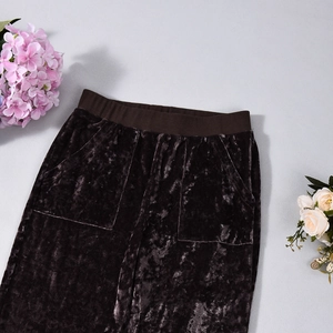 Detail of high waist velvet pants with ribbed waistband and side pockets in coffee brown
