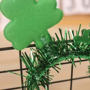 Detail of St. Patrick's Day headband with green felt clovers and spring tassels