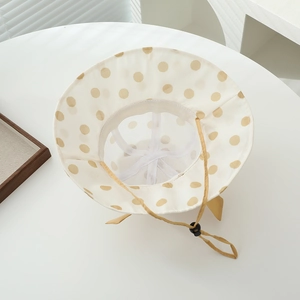 Detail of toddler sun hat with polka dot pattern, breathable mesh and adjustable strap