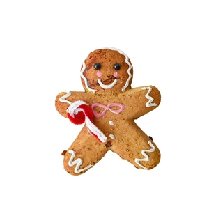 Christmas gingerbread man ornament with candy cane and white frosting texture decor