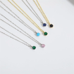 Detail of colorful round gemstone pendant necklaces with fine silver and gold chain sets