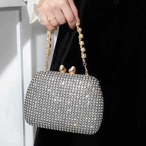Elegant silver rhinestone evening bag with heart-shaped clasps and diamond-encrusted chain