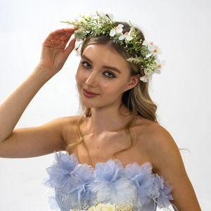 Elegant bridal floral headband with white flowers and green leaves for wedding photography