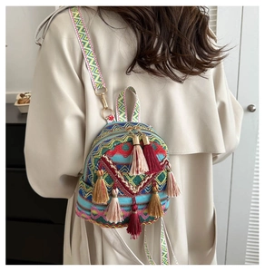 Detailed embroidery and colorful tassels on an ethnic style backpack worn by a model