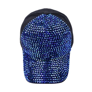 Close-up of sparkling blue and purple rhinestones on a black cotton baseball cap