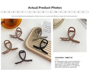 Macro detail of cross design matte hair claws in various Morandi colors with strong springs