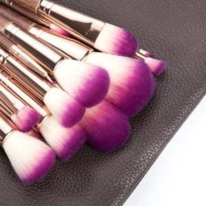 17pcs professional makeup brush set with purple bristles and wood handles on leather