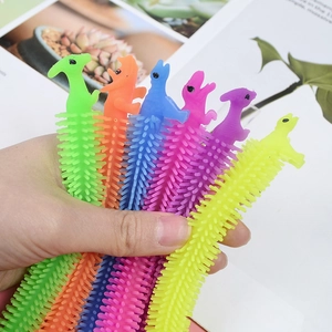 Colorful TPR dinosaur stress relief stretchy bracelets held in hand for sensory play