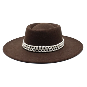 Detailed close-up of dark brown wool felt fedora with elegant white pearl decorative band