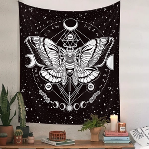 Detail of bohemian moth tapestry featuring moon phases and zodiac signs on a white wall