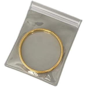 Frosted EVA jewelry pouch containing a golden round bangle on a clean white background