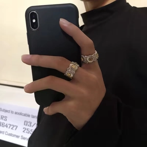 Elegant silver daisy rings with golden centers shown in a lifestyle hand gesture