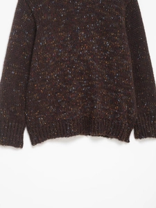 Close-up of brown knit sweater texture with colorful speckled yarn and ribbed hem