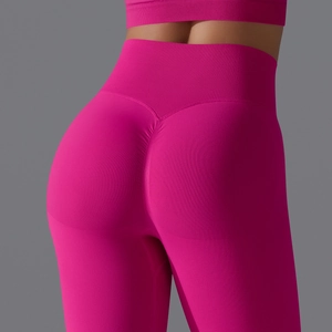 Macro detail of high-waist seamless scrunch leggings in vibrant rose pink sports fabric