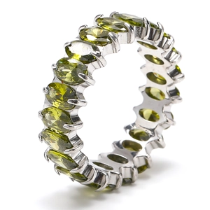 Detailed close-up of eternity ring with marquise-cut olive green stones in claw setting