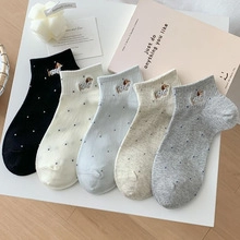 Detail showing five-pack of cotton socks with dog embroidery and subtle dot patterns