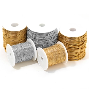 Detailed stack of five gold and silver metallic elastic cords for DIY jewelry making