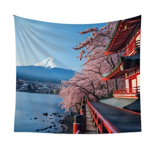 Detail of bohemian tapestry featuring Mount Fuji and cherry blossoms on a white wall