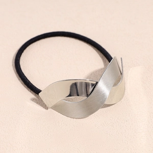 Detail of black elastic hair tie with textured silver metallic geometric ornament