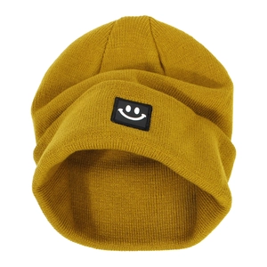 Mustard yellow ribbed knit beanie with a minimalist black smiley face patch for winter