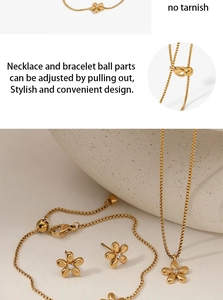 Detail of adjustable golden flower jewelry set with necklace, bracelet and earrings