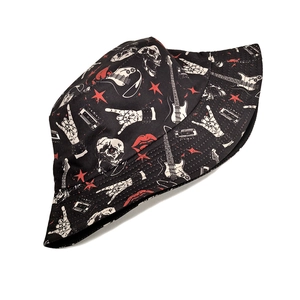 Detail of rock and roll patterns including electric guitars and skulls on black bucket hat
