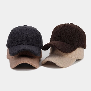 Texture detail of thick faux lamb wool baseball caps in four assorted neutral colors