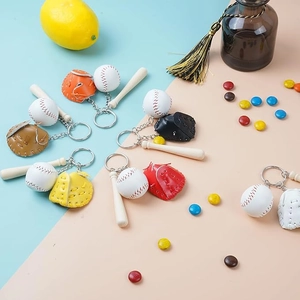 Detailed close-up of mini baseball keychains featuring leather gloves and wooden bats