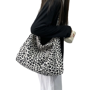 Large capacity corduroy leopard print tote bag with long shoulder strap worn by model