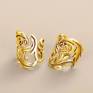 Detailed view of vintage gold-plated leaf ear cuffs with intricate hollow engraving texture