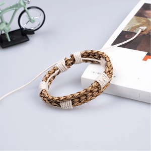 Handmade braided brown leather bracelet with adjustable cord on decorative lifestyle props