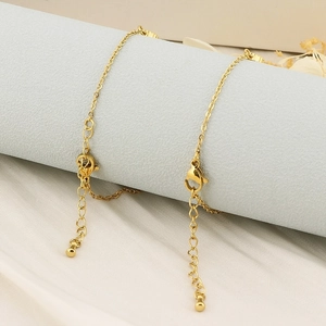 Detail of delicate gold titanium steel bracelets with lobster clasp and extender chains
