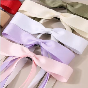 Elegant satin bow hair clips in assorted colors like pink, white and olive green