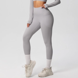 Detail view of high waist yoga leggings with functional side pockets in light grey