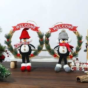 Christmas penguin wreath decor with welcome banner on rustic wooden bench setup