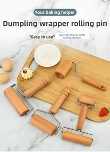 Macro view of four different wooden pastry rollers with stainless steel frames on a board