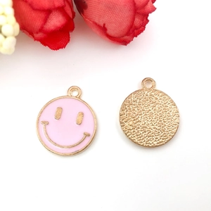 Detailed front and back view of pink enamel smiley face round metal pendants for DIY crafts