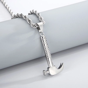Detailed macro shot of the stainless steel hammer pendant with a textured grip handle