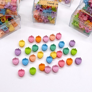 Set of colorful strawberry shaped hair clips for baby girls in a clear storage box
