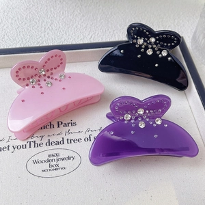 Sparkling rhinestone bow hair claw clips in pink, purple, and black acetate finish